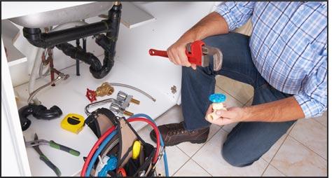 Plumber working on a sink