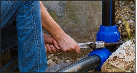 Man holding wrench on a pipe